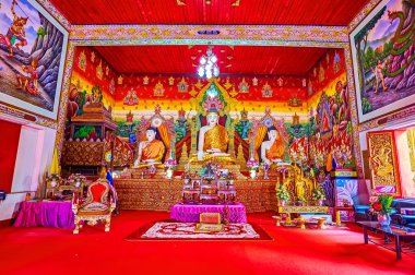 CHIANG MAI, THAILAND - MAY 3, 2019: Interior of the Viharn of Wat Chetawan with Burmese style Buddha images and colored murals, Chiang Mai, Thailand