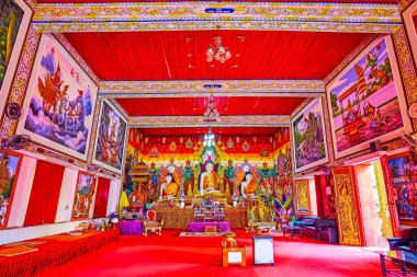 CHIANG MAI, THAILAND - MAY 3, 2019: The red gamma Viharn of Wat Chetawan with Burmese style Buddha images and colored murals, Chiang Mai, Thailand