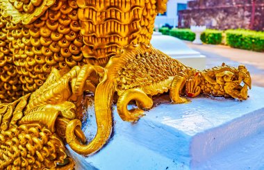 The tiny dragon-like sculpture of Mom mythic creature at the feet of bigger one, Wat Umong Mahathera Chan, Chiang Mai, Thailand