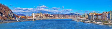 Panorama of bright blue Danube River, reflecting the sunny sky and beautiful white Elisabeth Bridge against the Buda Castle, Budapest, Hungary