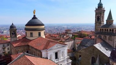 Citta Alta Panorama Palazzo della Podesta saat kulesinin tepesinden, Capella Colleoni 'nin kırmızı kiremit çatı, kubbe ve kulelerini, Santa Maria Maggiore Bazilikası, Bergamo Katedrali Kubbe, Lombardy, İtalya' da altın heykeli olan