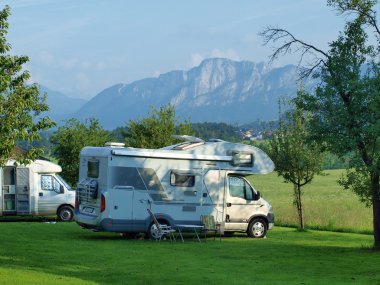 holidays with campervan in the foothills of the Alps clipart