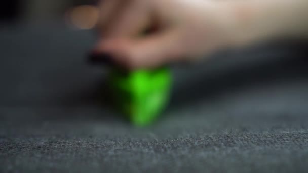 A woman cleans the fabric from dirt with a large brush. Green brush in a womans hand close-up. Slow motion. — Stock Video