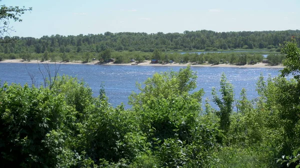 View of the river and hills from behind the trees — Stock Photo, Image