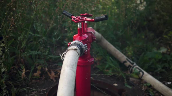 Fire hydrant in the well. Pumps water to extinguish a fire — Stock Photo, Image