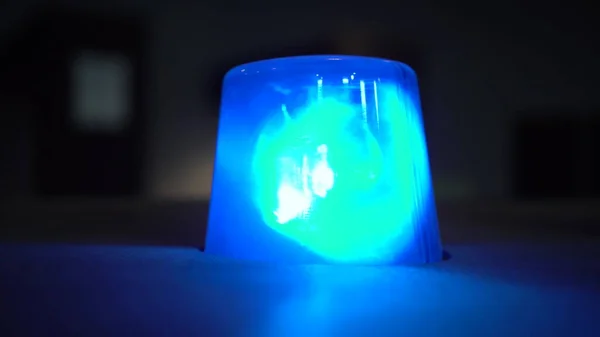Blue flashing warning light in the dark close up. Stock Image