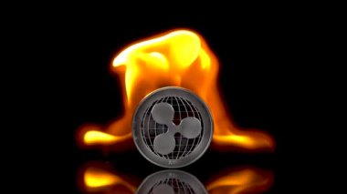 Dalgalanma - XRP madeni parası izole edilmiş siyah bir arkaplanda alev alır. Yavaş çekim 250 fps.
