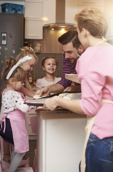 Family cooking cookies together.
