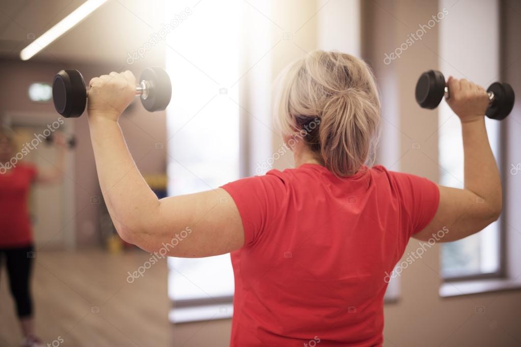 Mature woman working out at the gym