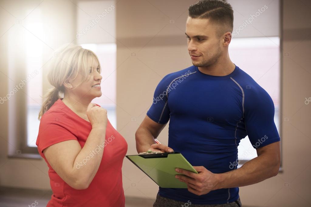 Mature Woman working out with coach
