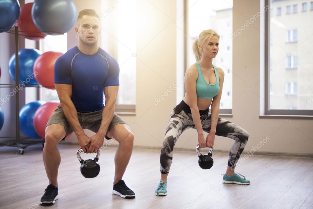 Fit couple lifting heavy kettles