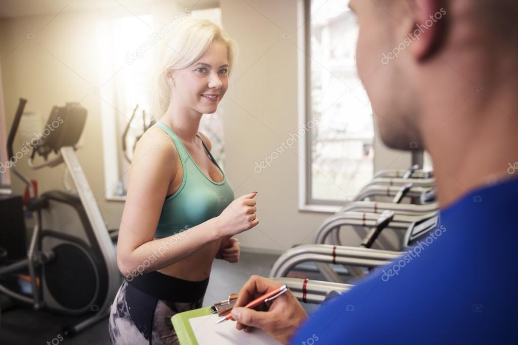 Woman exercising with instructor