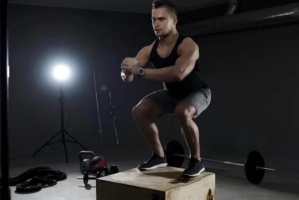 Man exercising on the wooden box — Stock Photo, Image