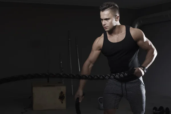 Strong man pulling exercise ropes — Stock Photo, Image
