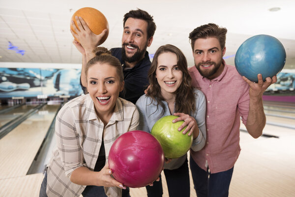Friends having fun in bowling club