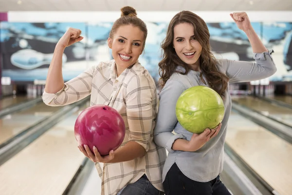 Girls holding bowling balls