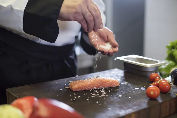 Šéfkuchař připravuje ryby s kořením — Stock fotografie