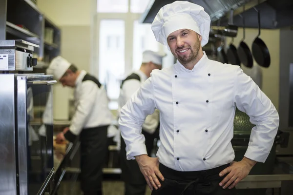 Cheerful chef in his kitchen — Stock Photo, Image