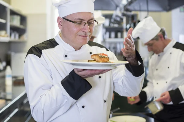 Chef smelling his dish — Stock Photo, Image