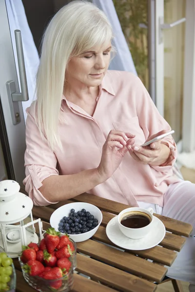 Starsza kobieta relaksując się w Znakomity rano — Zdjęcie stockowe