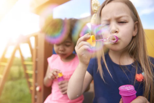 Kleine meisjes met plezier met zeepbellen — Stockfoto