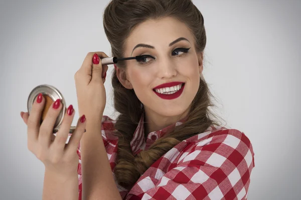 Pin up girl almost finish her make up