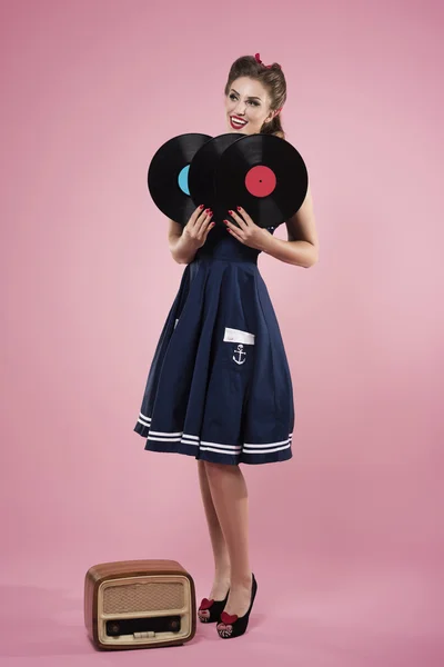 Pin up woman holding vinyl records — Stock Photo, Image