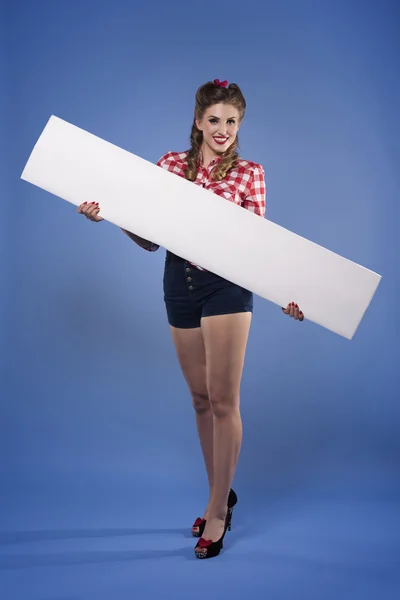 Pin up girl holding horizontal placard — Stock Photo, Image