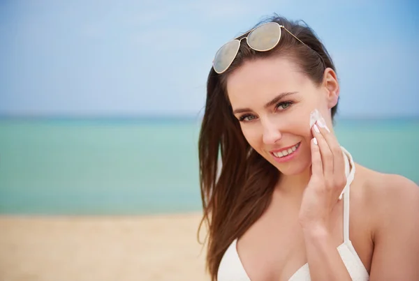 Applying suntan lotion on the face — Stock Photo, Image