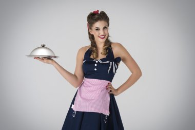 Pin up girl holding dinner in hand.  clipart
