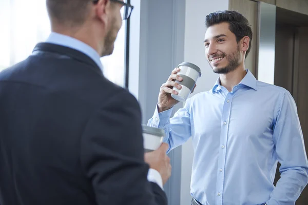 Businessmen making a sip of coffee — Stock Photo, Image