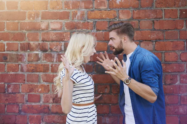 Young couple arguing very loudly