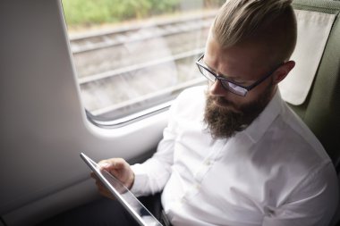 businessman working on tablet during the travel  clipart