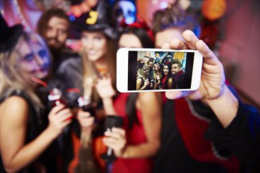 Man taking selfie of friends at party   clipart