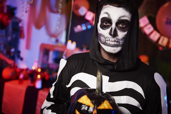 Scary skeleton with a pumpkin — Stock Photo, Image