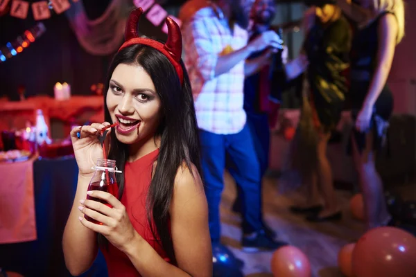 Woman drinking a red drink — Stock Photo, Image