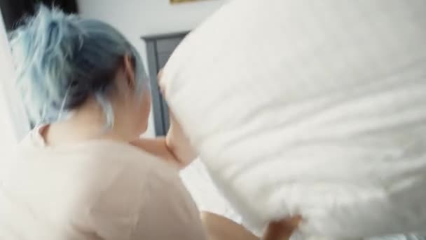 Tracking video of lesbian couple have fun during pillow fight. Shot with RED helium camera in 8K.