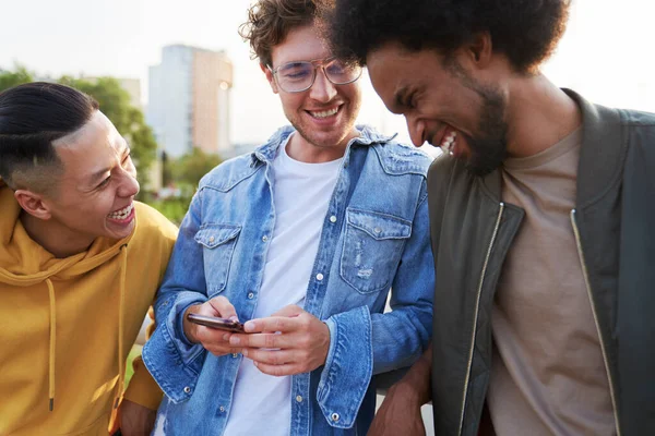 Three Young Men Laughing Something Holding Mobile Phone — Stock Photo, Image
