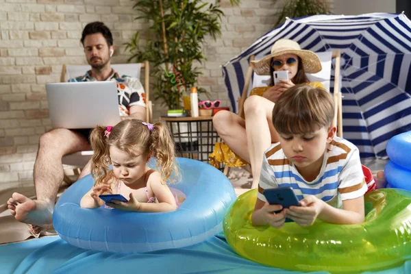 Family on vacation at home with electronic devices