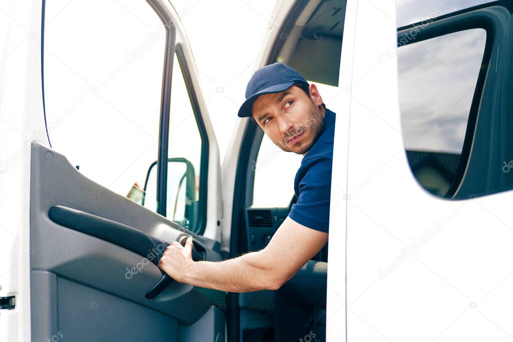Man backing out delivery van                               