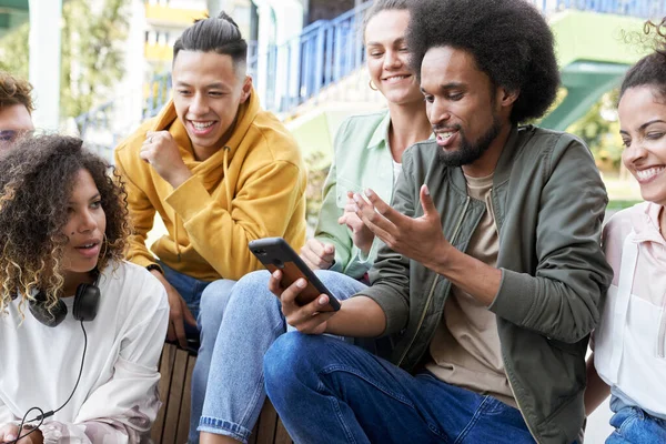 Group Smiling Young Friends Sitting Together Mobile Phone — Stock Photo, Image
