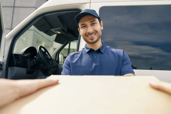 Close Smiling Courier Giving Package — Stock Photo, Image