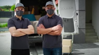 Koruyucu maskeli iki teslimatçının video portresi. 8K 'da kırmızı helyum kamerayla çekildi..