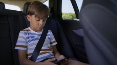 Arabadayken cep telefonlu bir çocuğun videosu. 8K 'da kırmızı helyum kamerayla çekildi..