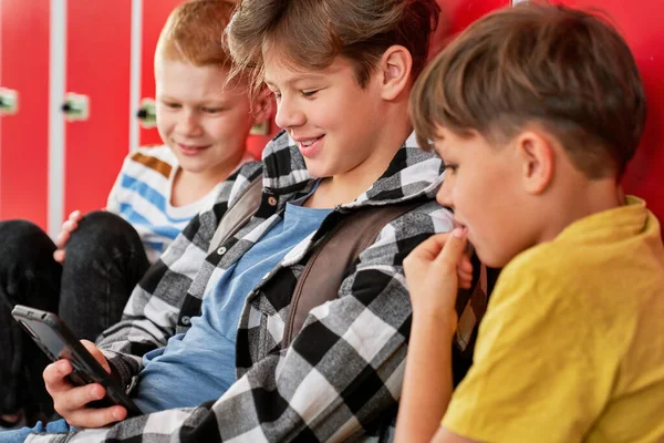 Three Schoolboys Sitting Looking Phone — Stock Photo, Image