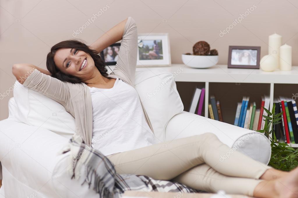 Laughing woman on sofa
