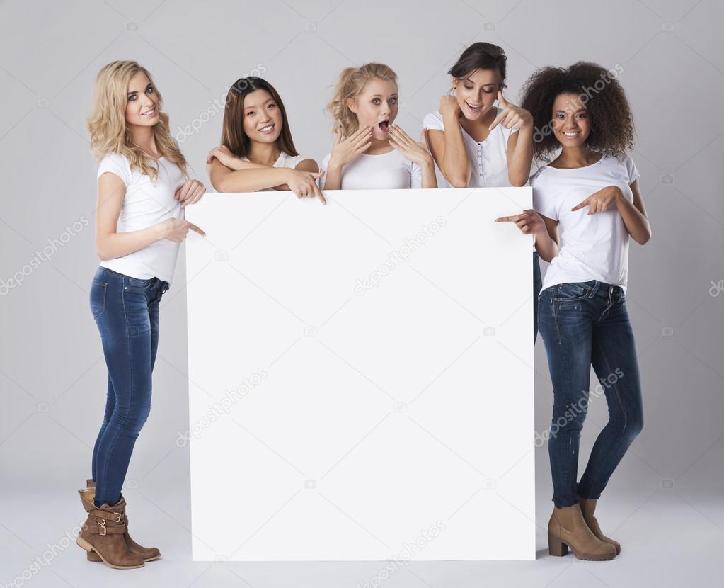 Women holding empty white board