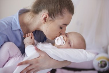 Mother with her baby daughter clipart