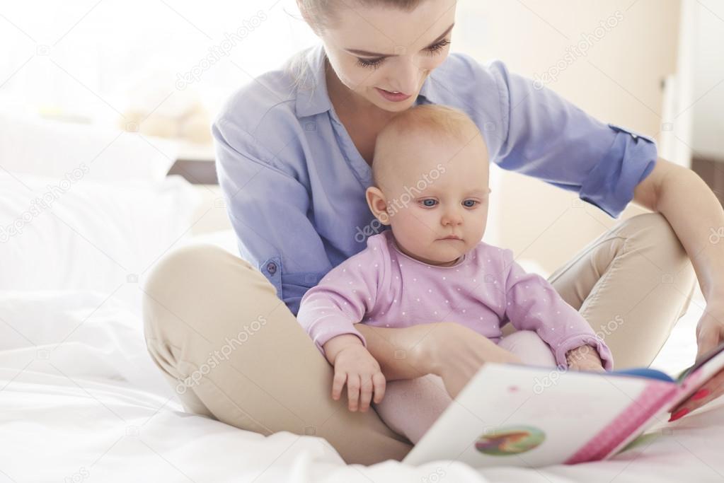 Mother Reading  to her baby