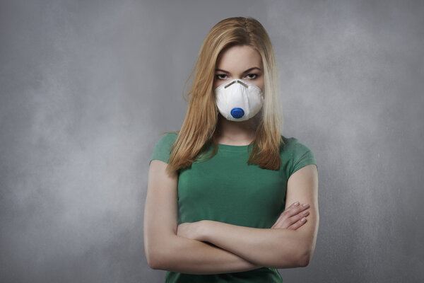 Young woman in air pollution concept